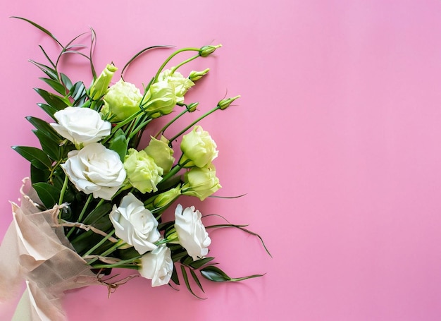 A bouquet of flowers on a pink background
