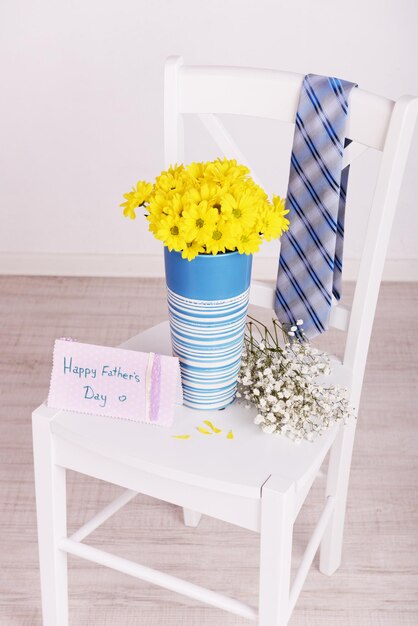 Bouquet of flowers and tie on Fathers Day in room