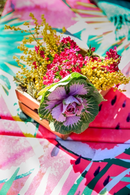 Bouquet of flowers on watermelon blanket