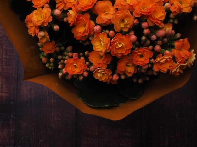 A bouquet of flowers with orange flowers in the middle