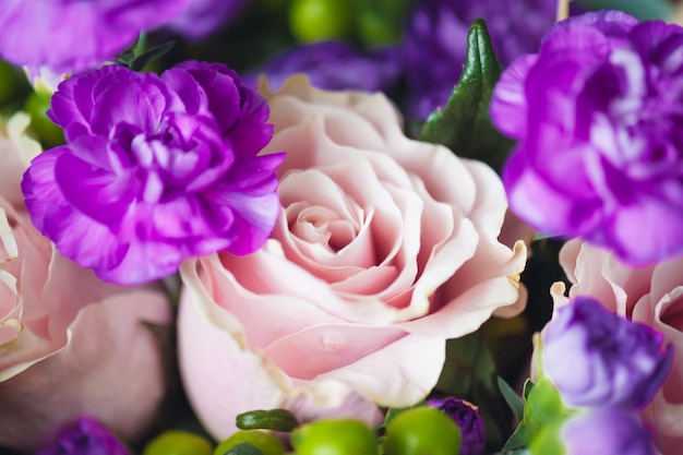 A bouquet of flowers with a pink flower in the middle