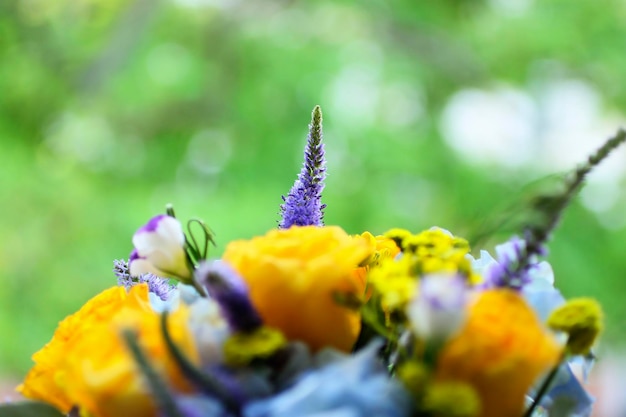 Bouquet of flowers with yellow rosesThe concept of male careBeautiful wildflowers