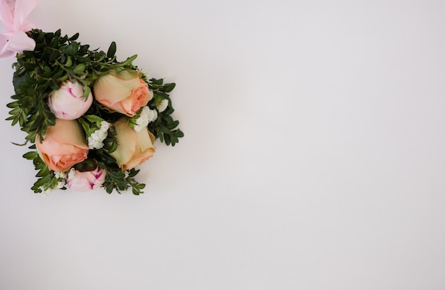 A bouquet of fresh flowers on a white background with a place for text. Wedding bouquet with roses