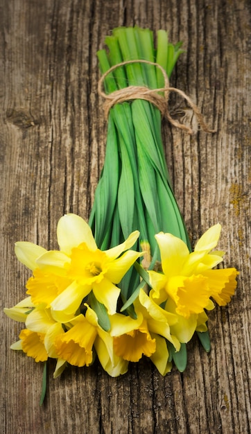 Bouquet of fresh spring flowers daffodils on wooden