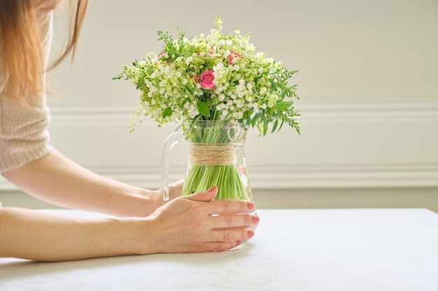 Bouquet of fresh spring flowers of pink roses and lily of the valley