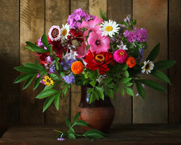 A bouquet of garden flowers in a clay jug