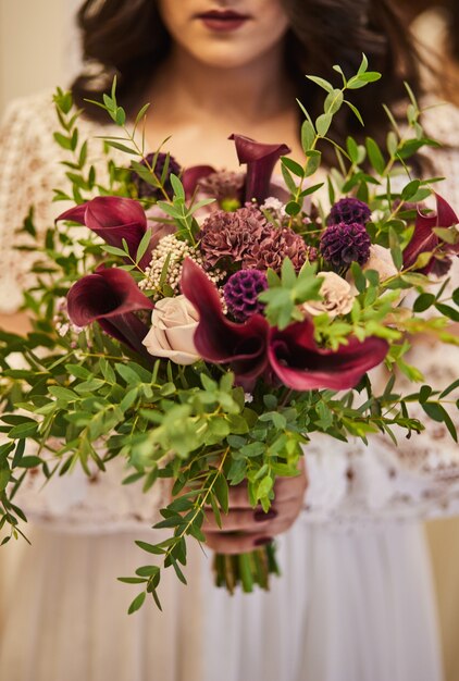 Bouquet in hands of the bride