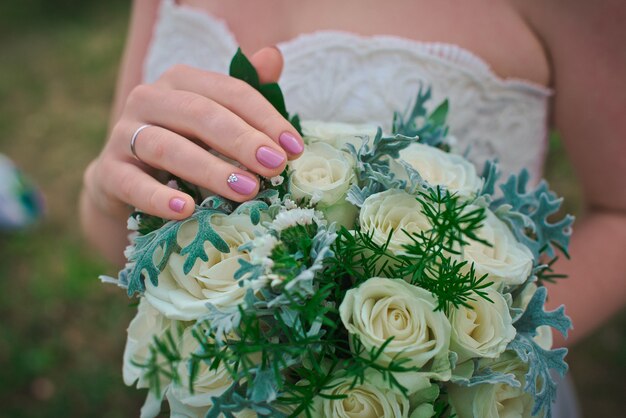 Bouquet in the hands of the bride 