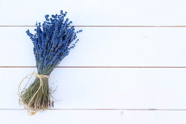 Bouquet of lavender flowers on white wooden board