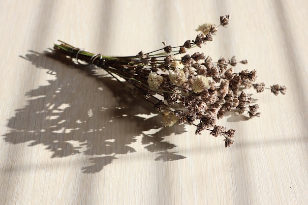 Photo a bouquet of lavender and wildflowers collected in a field lies on a light table in autumn