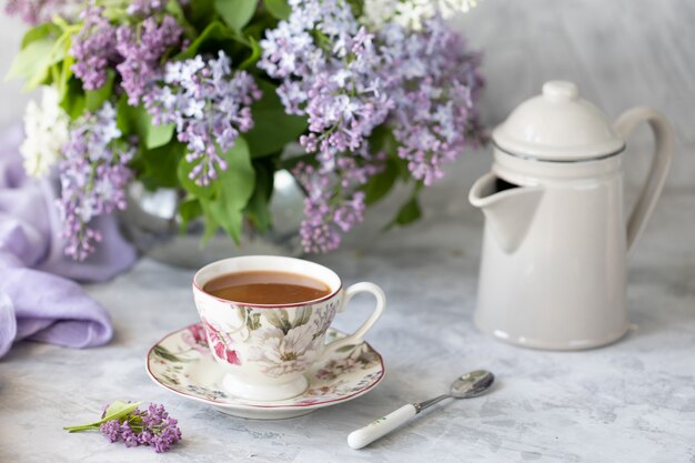 A bouquet of lilacs, a Cup of coffee,