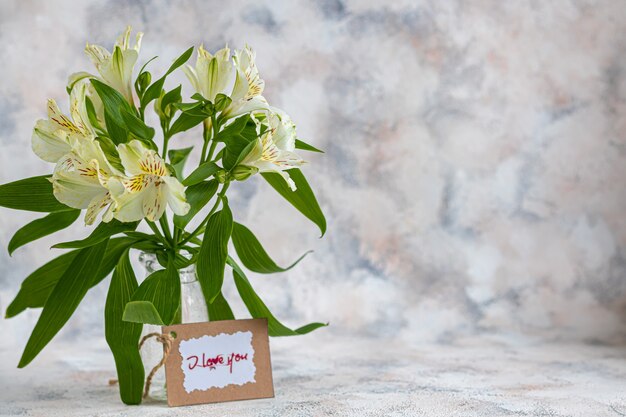 A bouquet of lilies on a light background.  Copy space.