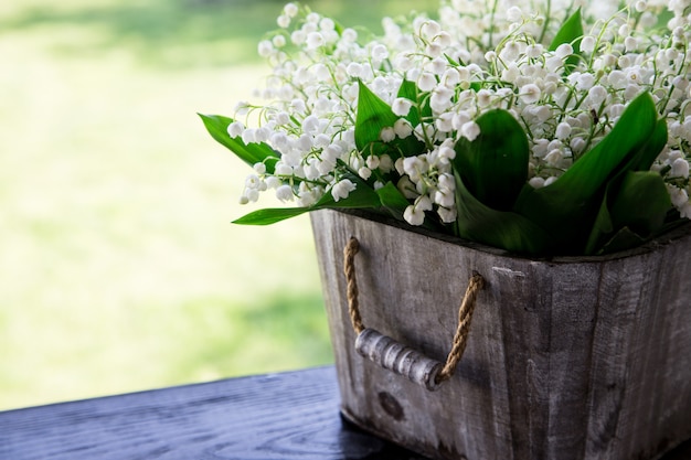 Bouquet of lilies of the valley in a basket. 