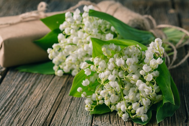 Bouquet lily of the valley on natural wooden background