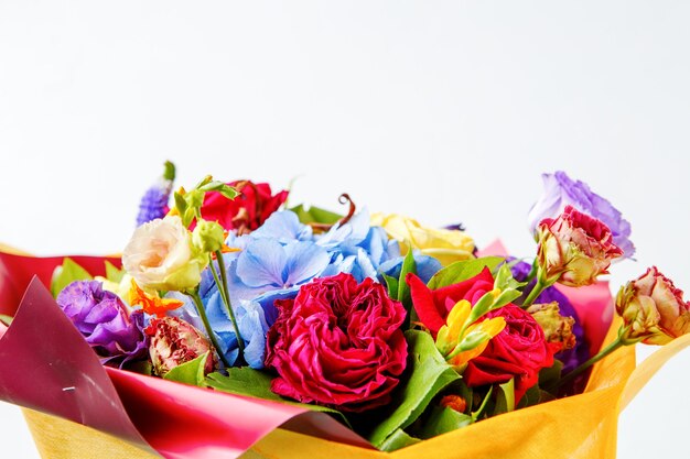 Bouquet of multicolored roses on empty white background