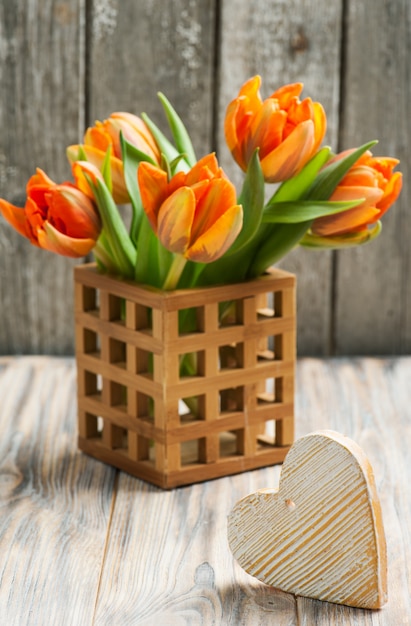 Bouquet of orange tulips and heart