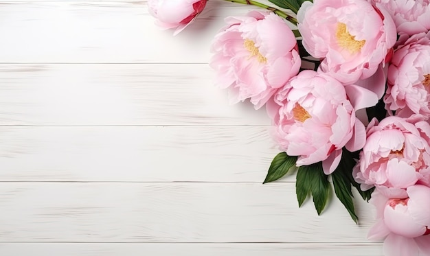Bouquet of peonies on a white wooden table top view flat lay copy space