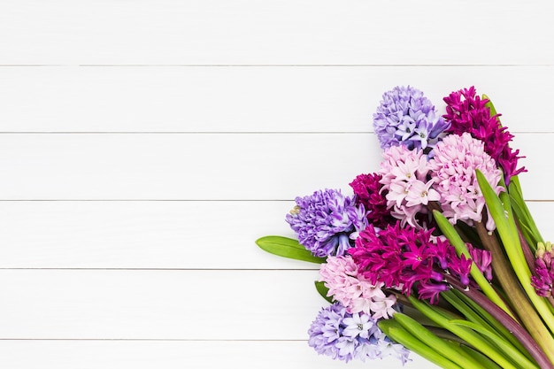 Bouquet of pink hyacinth flowers on white wooden