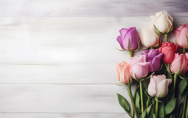 A bouquet of pink and purple roses on a white wooden table.