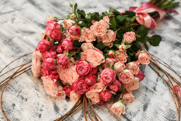 A bouquet of pink roses is on a table