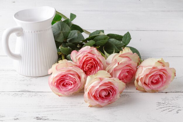 Bouquet of pink roses on old wooden board vintage toning