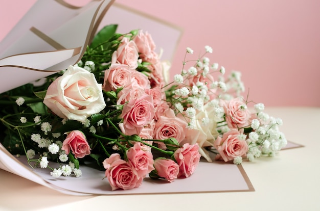 Photo bouquet of pink roses on pink background, close-up photo