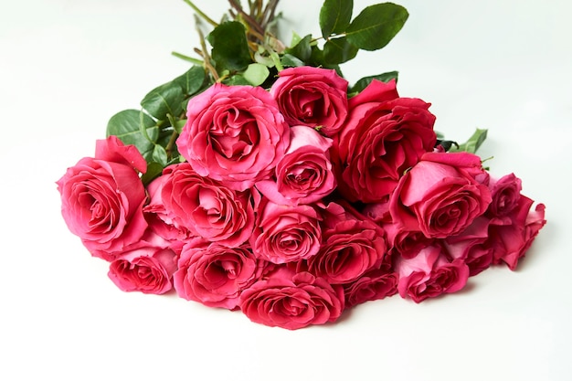 Bouquet of pink roses on white background with copy space.