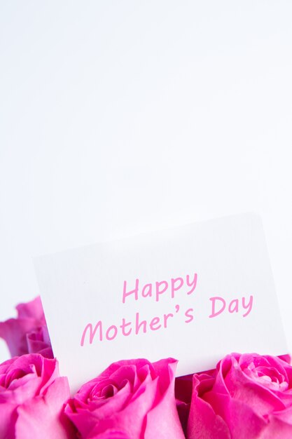 Bouquet of pink roses with happy mothers day card in pink