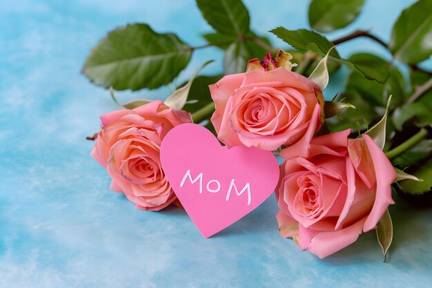 Photo bouquet of pink roses with a paper heart on a blue background