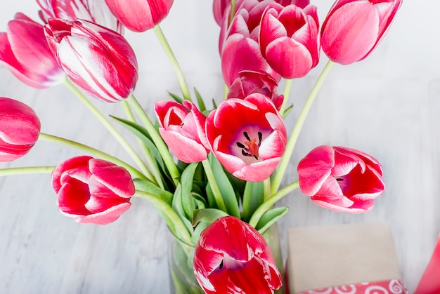 Photo bouquet of pink tulips closeup on grey background.