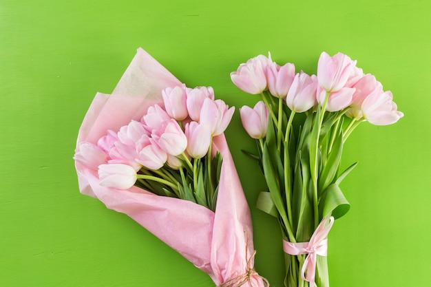 Bouquet of pink tulips on a green background.