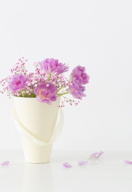 bouquet of pink tulips and gypsophila on   white table