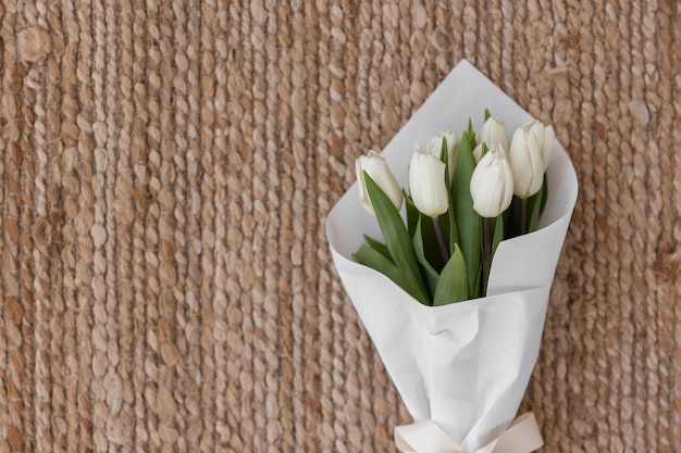 Bouquet of pink tulips on pink background Mothers day Valentines Day Birthday celebration concept Greeting card Copy space for text top view