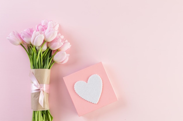 Bouquet of pink tulips on a pink background.