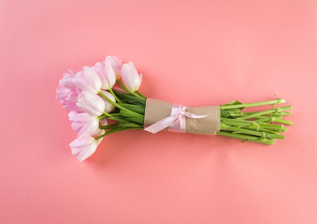 Bouquet of pink tulips on a pink background.