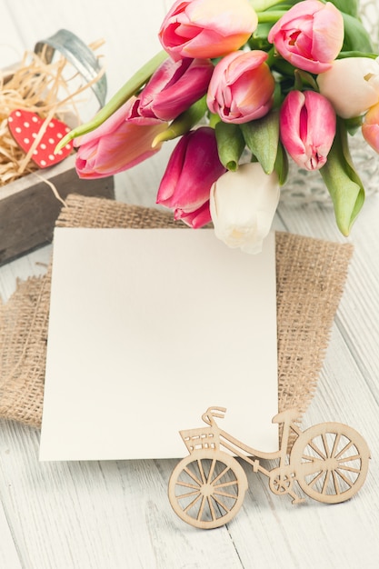 Bouquet of pink tulips with blank card