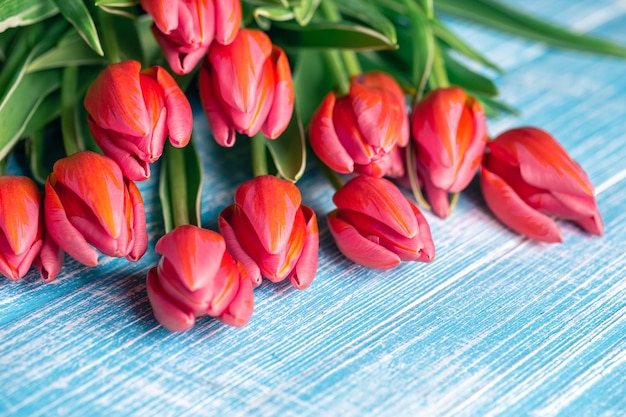 Bouquet of pink tulips on a wooden background closeup