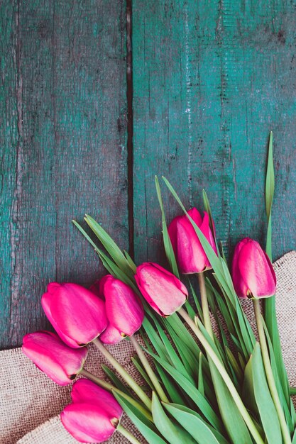 Bouquet of pink tulips on a wooden table