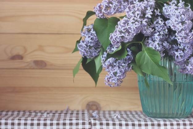 Photo bouquet of purple lilac in a vase.