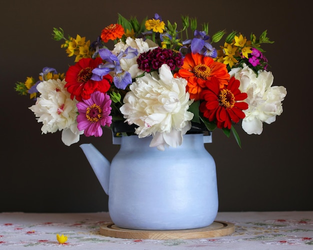 Bouquet in a purple teapot still life