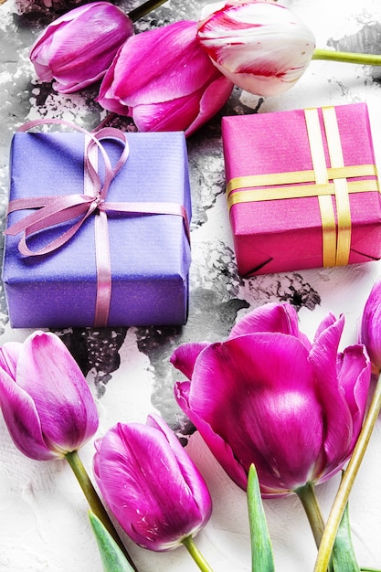 Bouquet of purple tulips and gift box