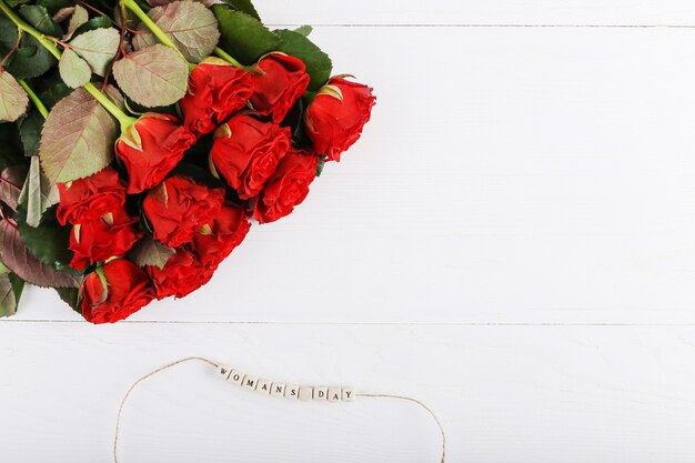 A bouquet of red roses and the inscription on the beads 