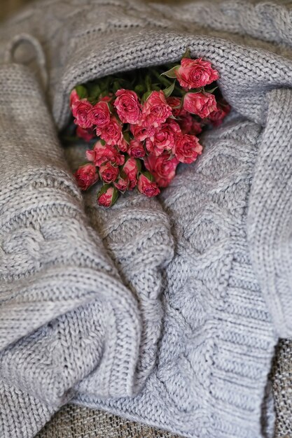 Photo bouquet of red roses on a textile sweater