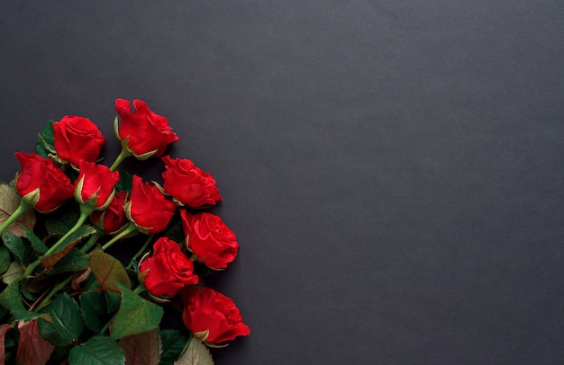 A bouquet of red roses with on a black background