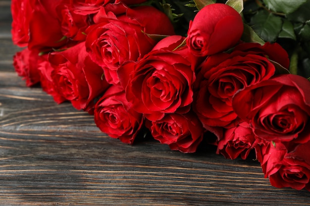 Bouquet red roses on wooden background, close up