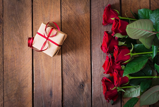 Bouquet of red roses on a wooden table.