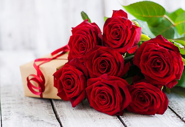 Bouquet of red roses on a wooden table.