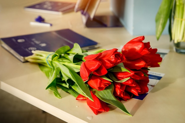 Bouquet of red spring tulips on office table