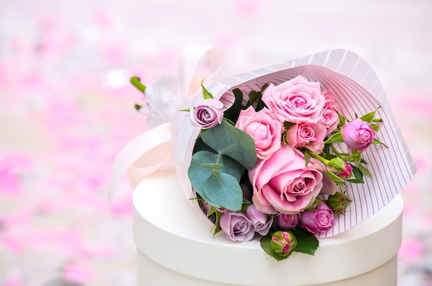 Bouquet of roses on a blurred background with space for text.