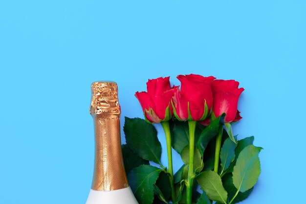 Bouquet of roses and champagne top view